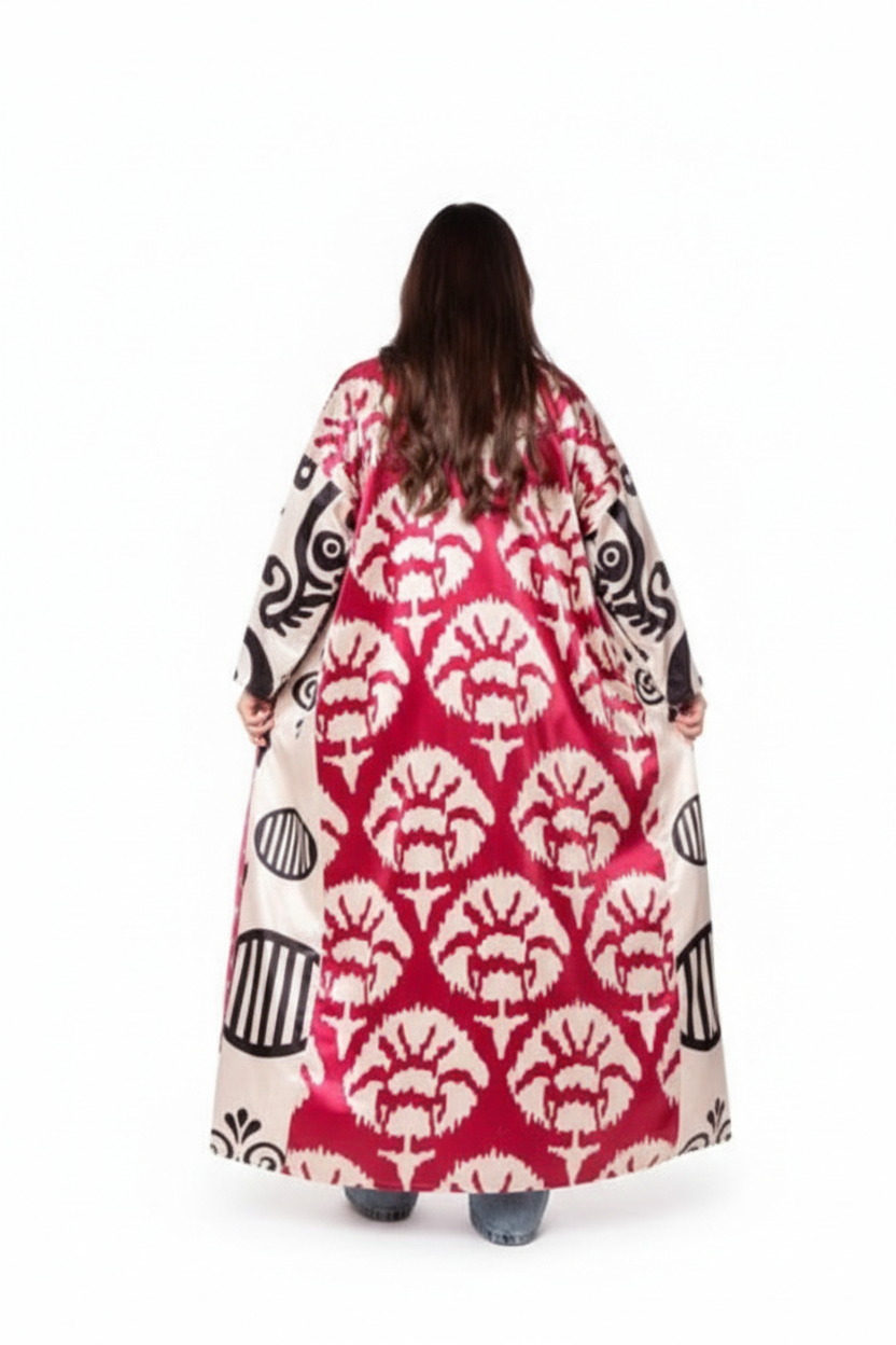 Person wearing a long, patterned dress with a red and white design on a white background
