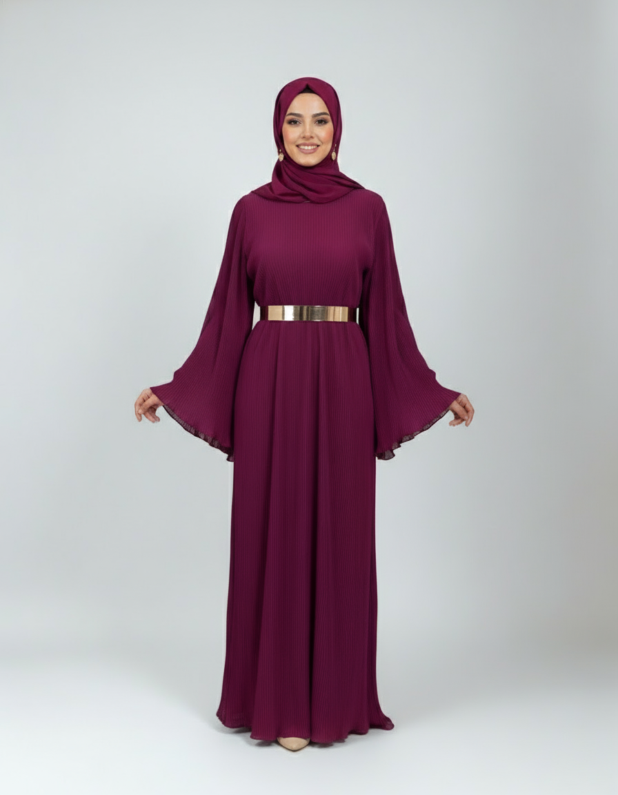 Woman wearing a burgundy dress with a gold belt on a white background