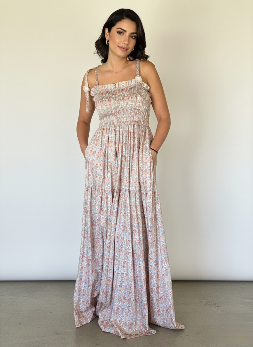 Woman wearing a floral dress against a plain background