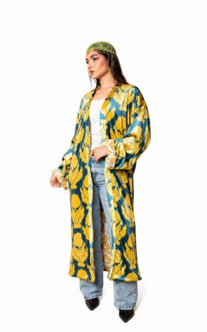 Woman wearing a yellow and blue floral patterned coat on a white background