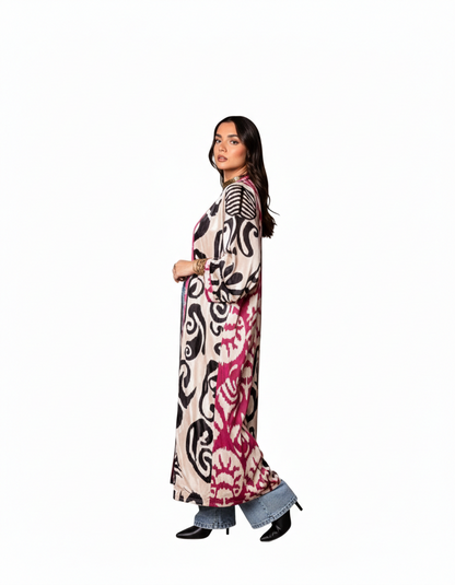 Woman wearing a long, patterned dress on a white background