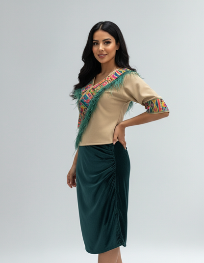 Woman wearing a beige top with colorful embroidery and a green skirt on a white background