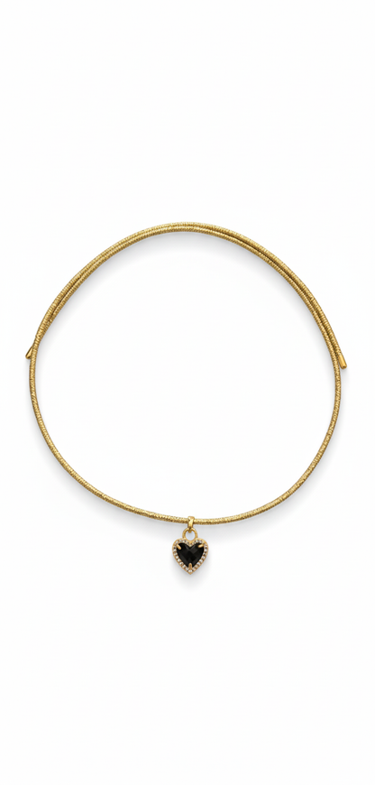 Gold bracelet with a heart-shaped black stone on a white background