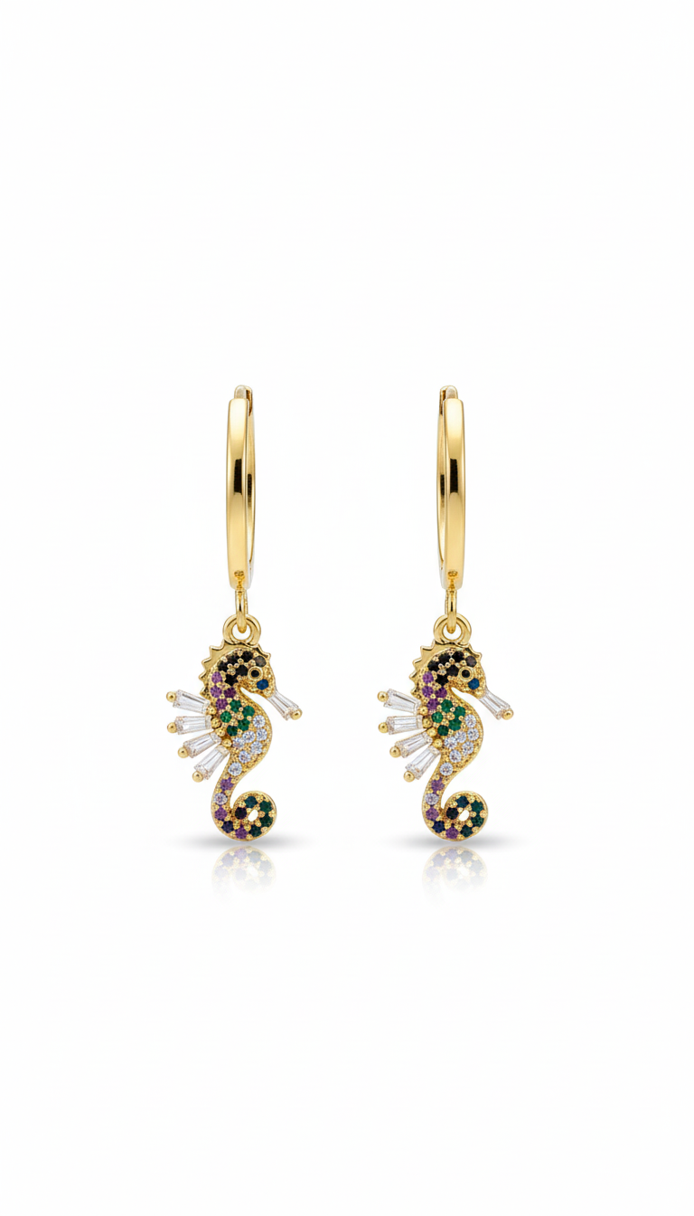 Gold seahorse earrings with gemstones on a white background