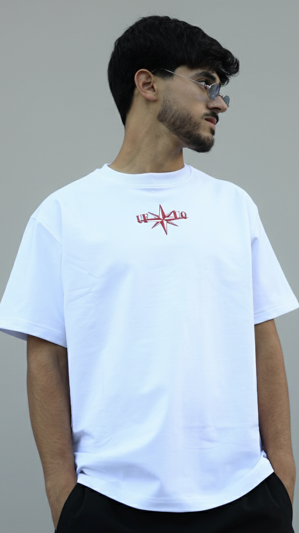 Man wearing a white t-shirt with a red logo on a gray background