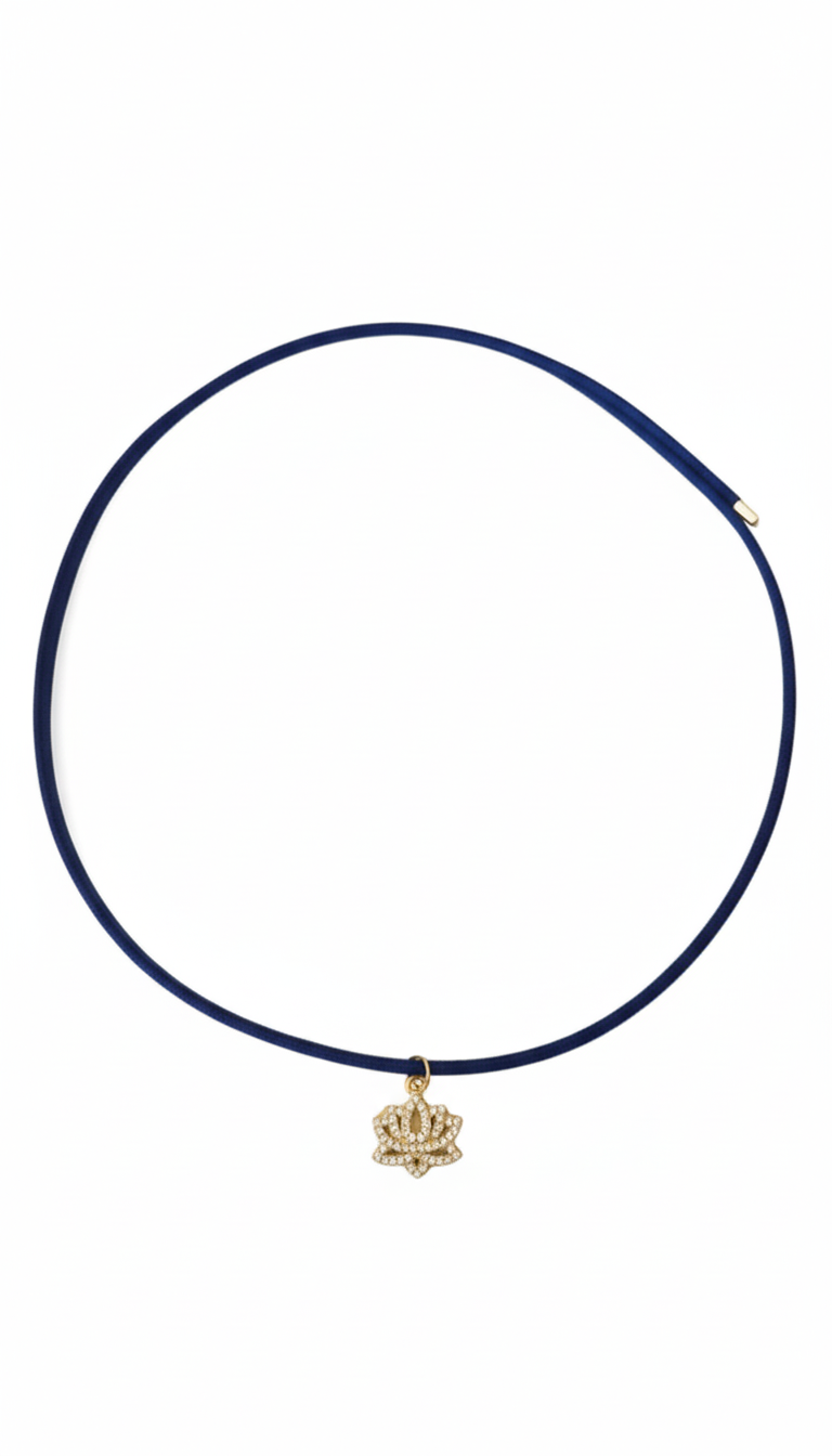 Navy blue choker necklace with a gold crown pendant on a white background