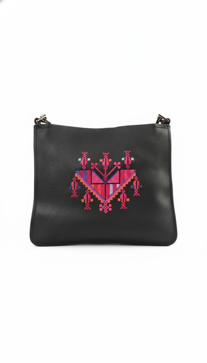 Black leather pouch with pink and red geometric embroidery on a white background
