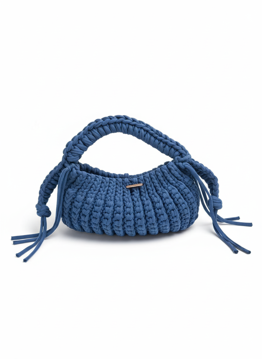 Blue woven handbag with tassels on a white background