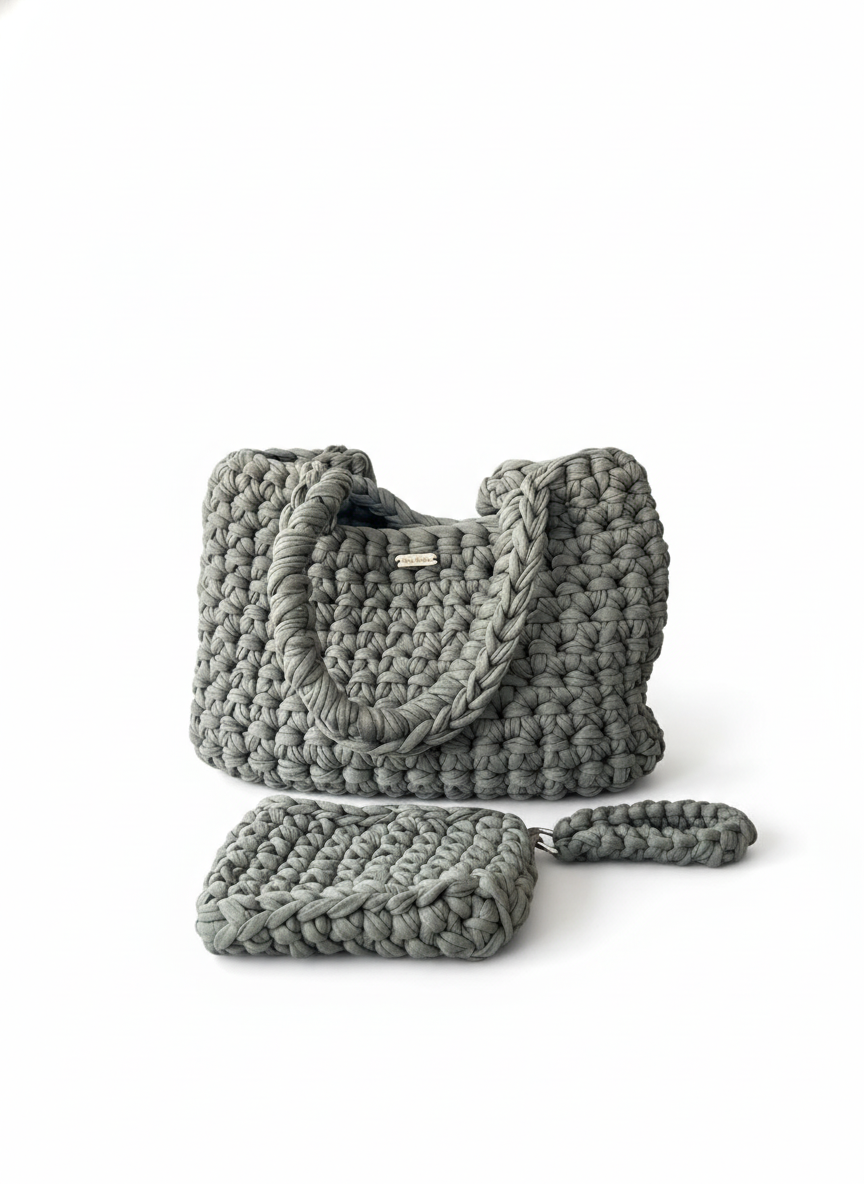 Gray knitted handbag with matching pouch on a white background