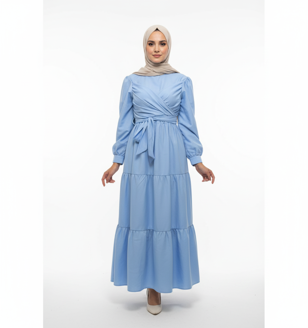 Woman wearing a light blue dress with long sleeves on a white background