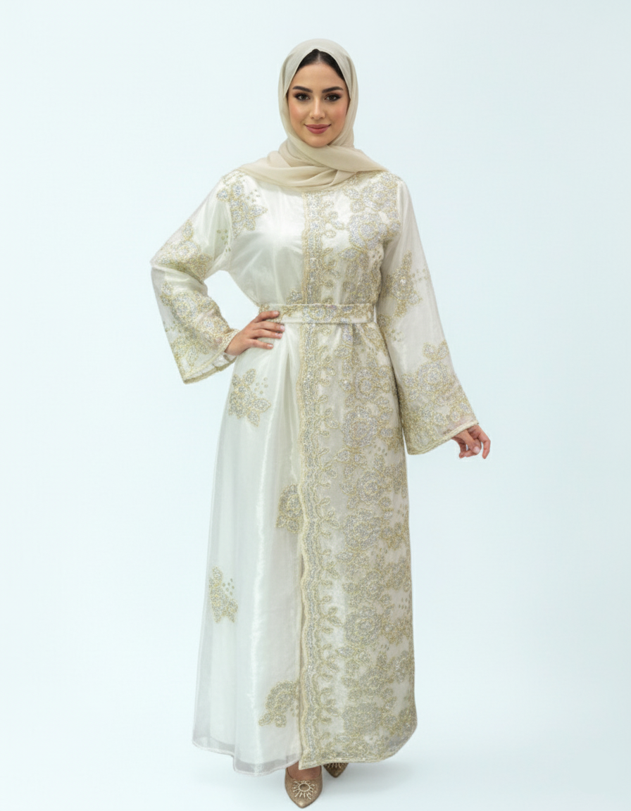 Woman wearing a long, light-colored embroidered dress with a matching hijab on a white background