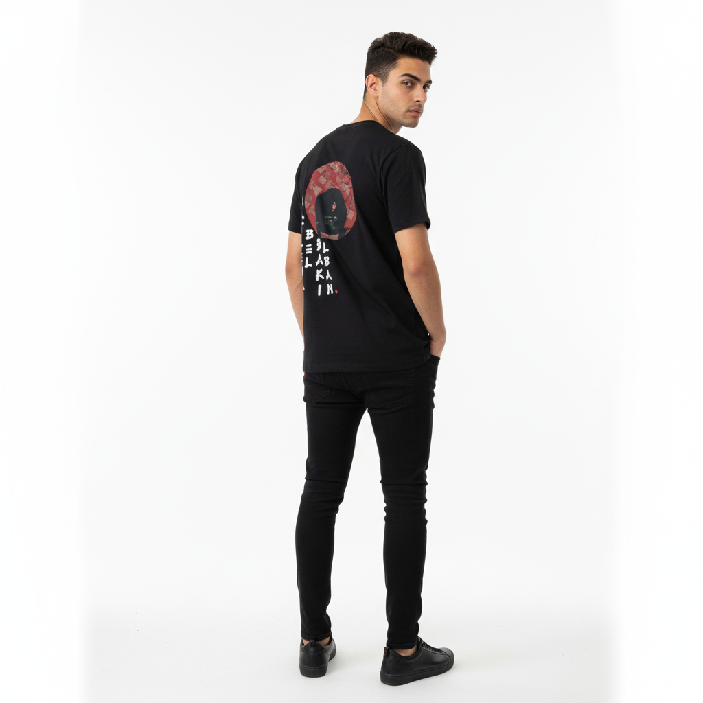 Man wearing a black t-shirt with graphic design on the back against a white background