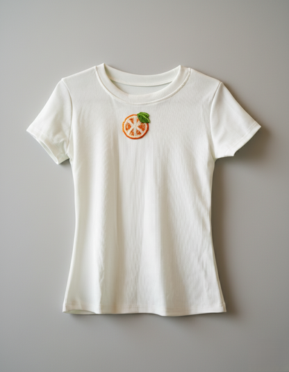 White t-shirt with a small graphic on a gray background