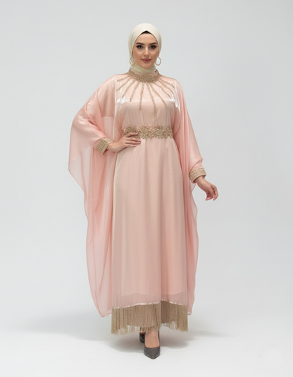 Woman wearing a pink dress with a sheer overlay on a white background