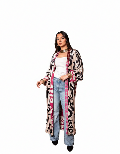 Woman wearing a long, patterned cardigan on a white background