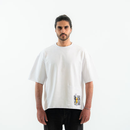 Man wearing a white t-shirt with a small graphic on a plain background