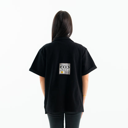 Person wearing a black t-shirt with a graphic on the back against a white background