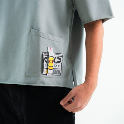 Gray shirt with a patch on the chest against a white background