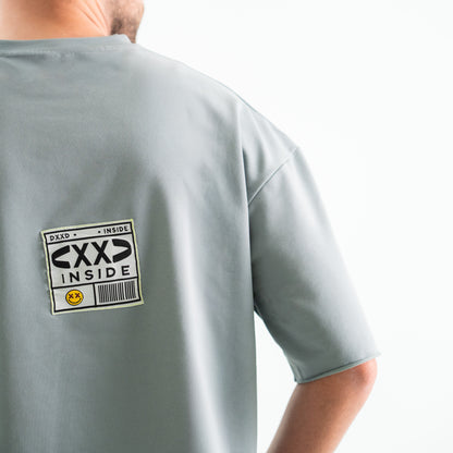 Gray t-shirt with 'CXXD INSIDE' label on the back against a white background