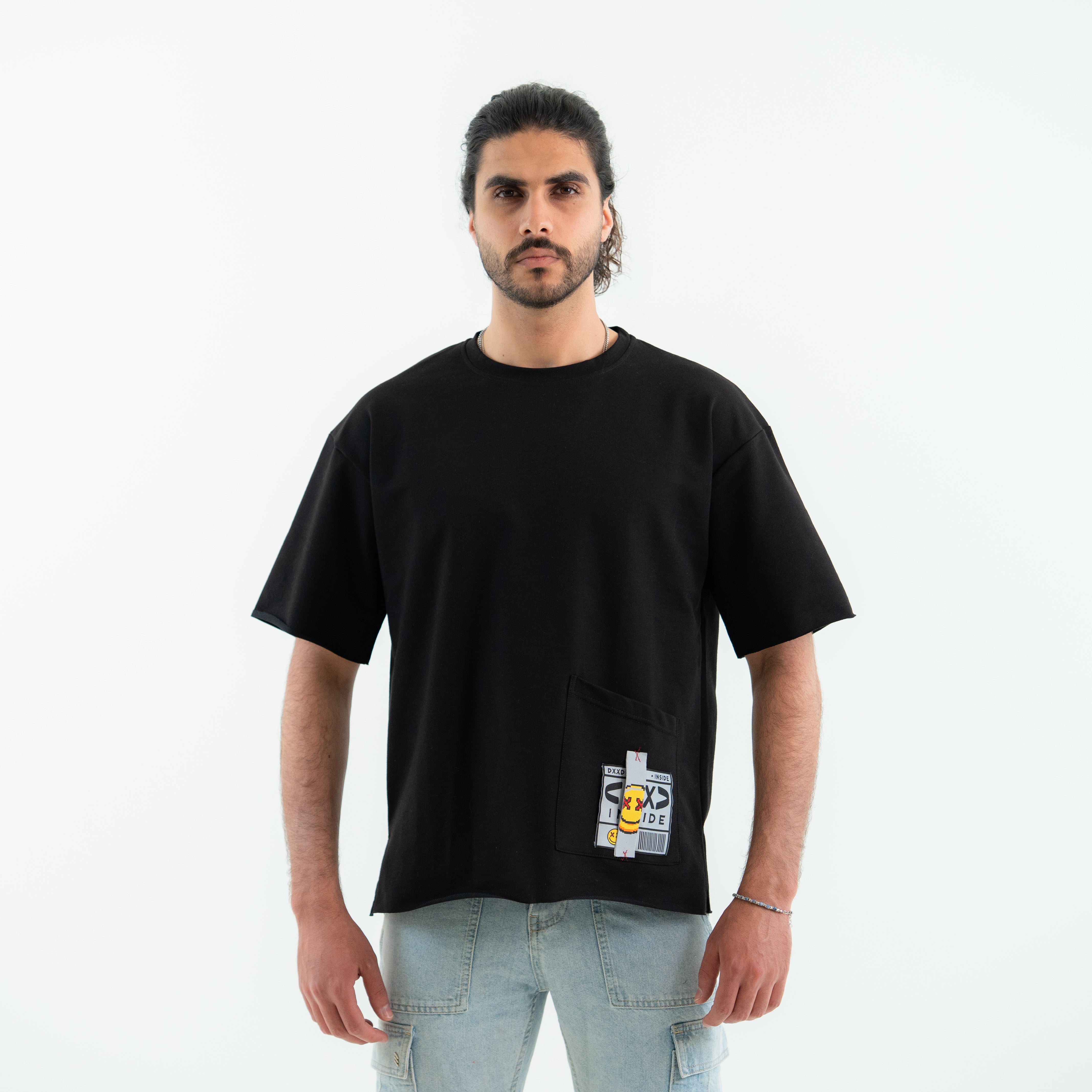 Man wearing a black t-shirt with a graphic design on a white background