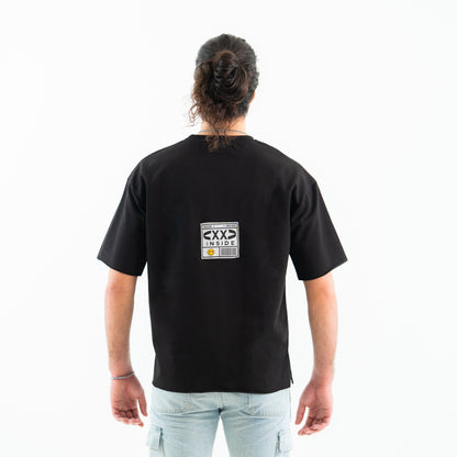 Person wearing a black t-shirt with a graphic on the back against a white background