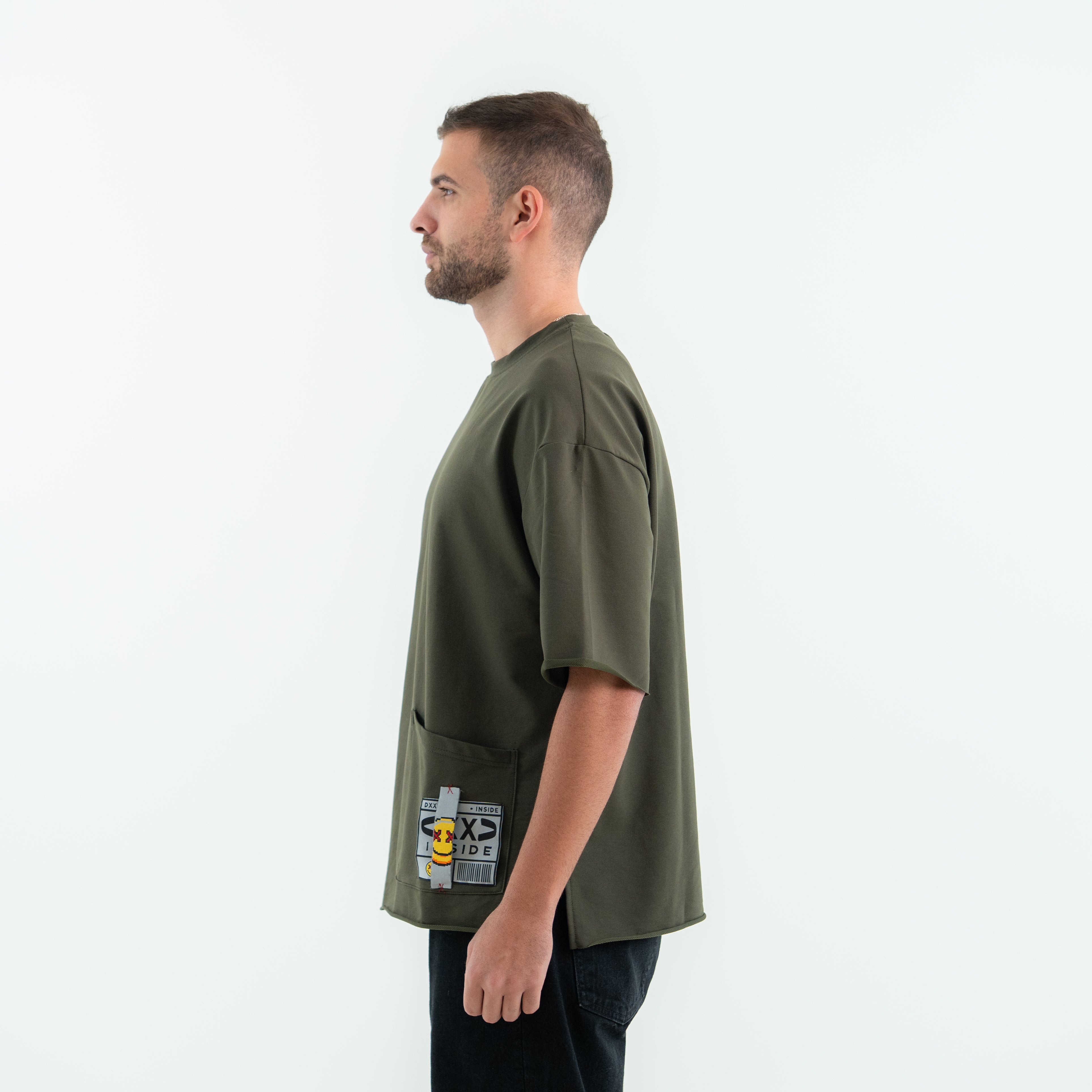Man wearing a green t-shirt with a graphic design on a white background