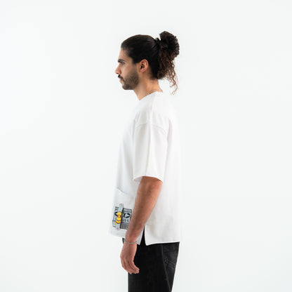 Person wearing a white t-shirt with a graphic design on a plain background