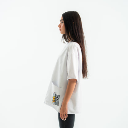Woman wearing a white oversized t-shirt with graphic designs on a white background