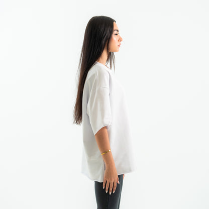Woman wearing a white oversized shirt on a white background