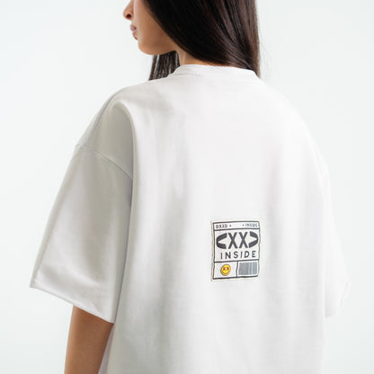 White t-shirt with a graphic design on the back, worn by a person.