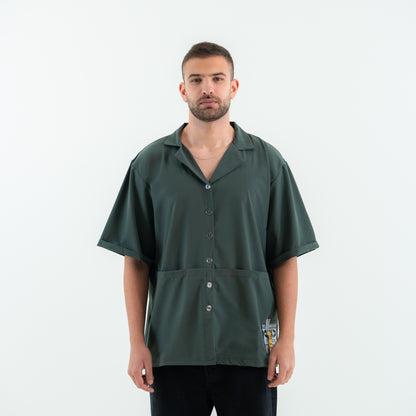 Man wearing a green short-sleeve shirt on a white background