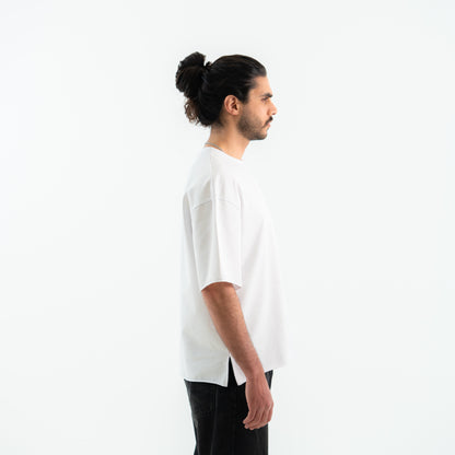 Man wearing a white t-shirt and black pants on a white background