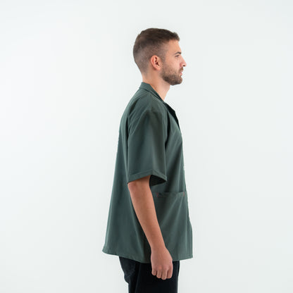 Man wearing a green oversized shirt on a white background