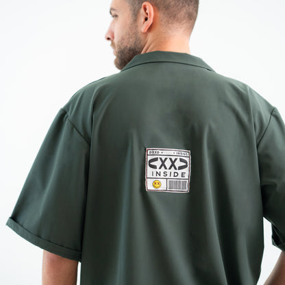 Person wearing a green shirt with a label on the back