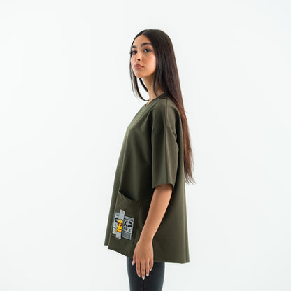 Woman wearing a green oversized t-shirt with a graphic design on a white background