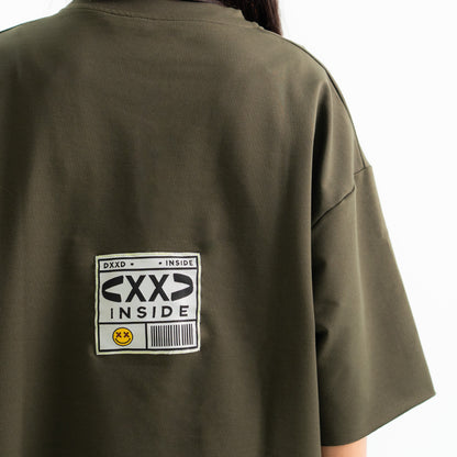 Green shirt with 'CXXD INSIDE' label on the back against a white background