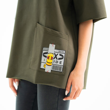 Green shirt with a pocket featuring a label on a white background