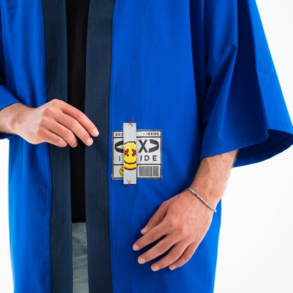 Person wearing a blue robe with a visible label on a white background