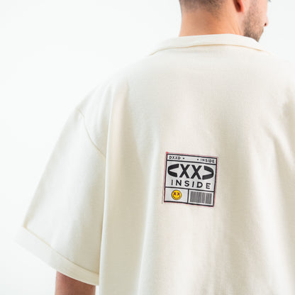 Person wearing a white t-shirt with a graphic design on the back