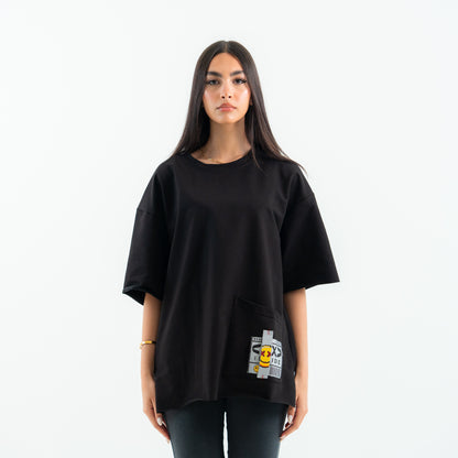 Person wearing a black oversized t-shirt with a graphic design on a white background