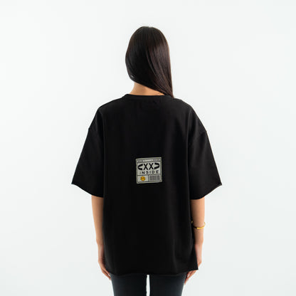 Person wearing a black t-shirt with a logo on the back against a white background