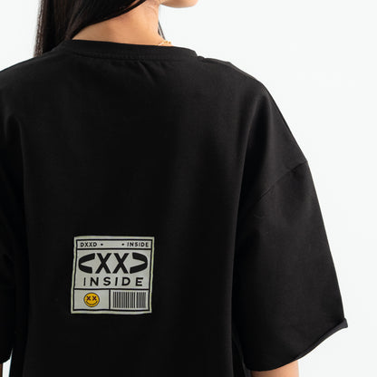Black t-shirt with a label on the back, worn by a person.
