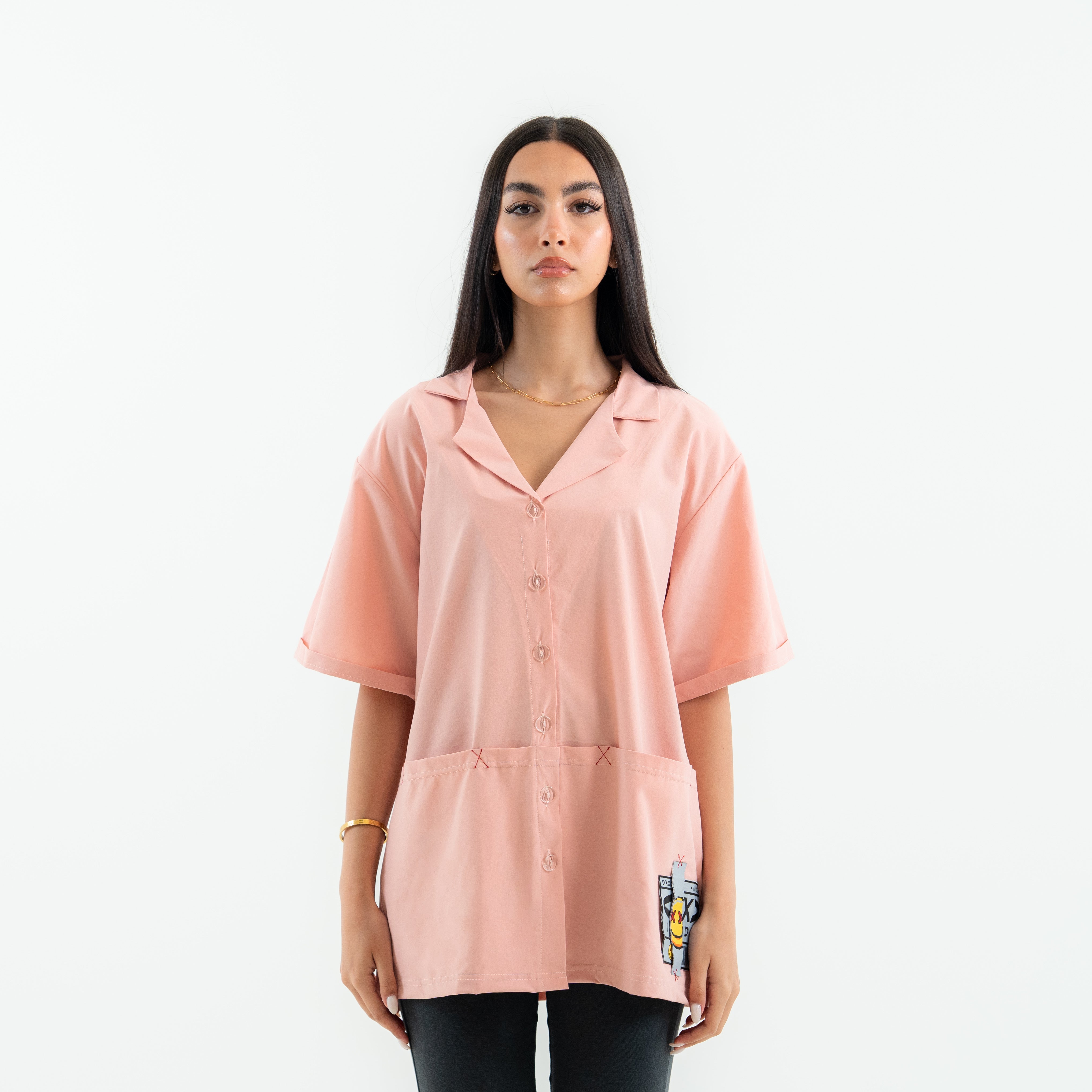 Woman wearing a pink oversized shirt on a white background