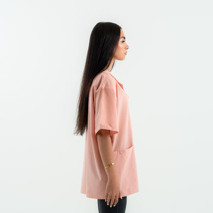Woman wearing a pink blouse against a white background
