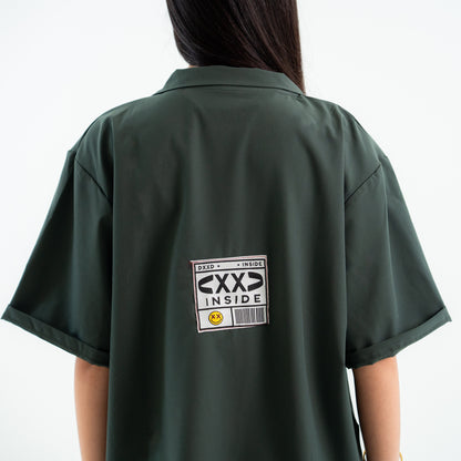 Green shirt with a label on the back against a white background