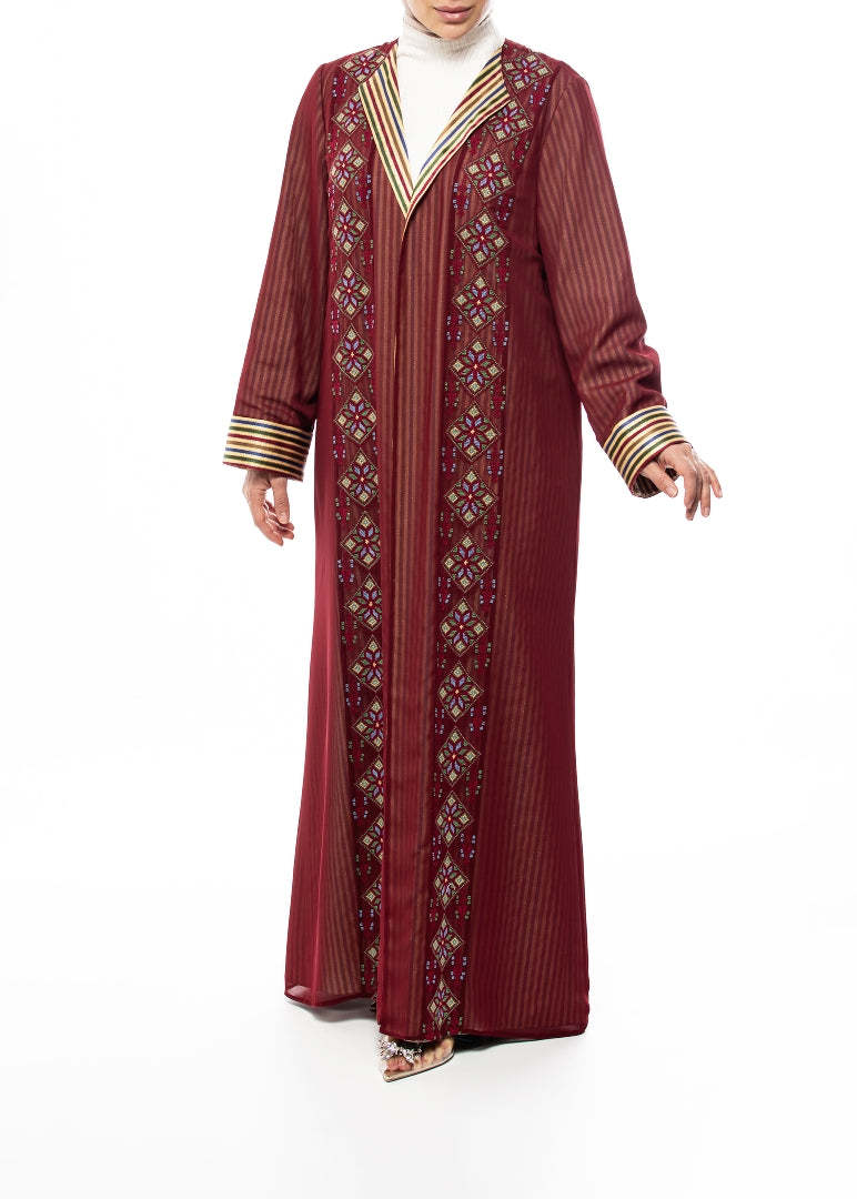 Maroon embroidered abaya with gold accents on a white background