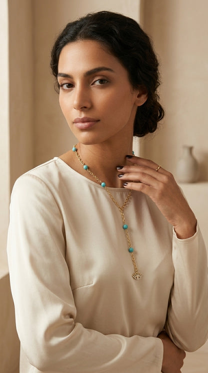 Woman wearing a necklace with a neutral background