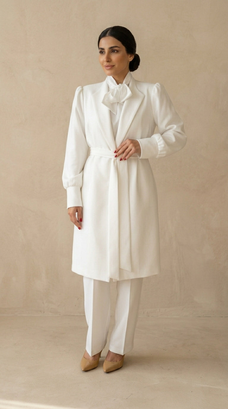 Woman wearing a white outfit with a beige background