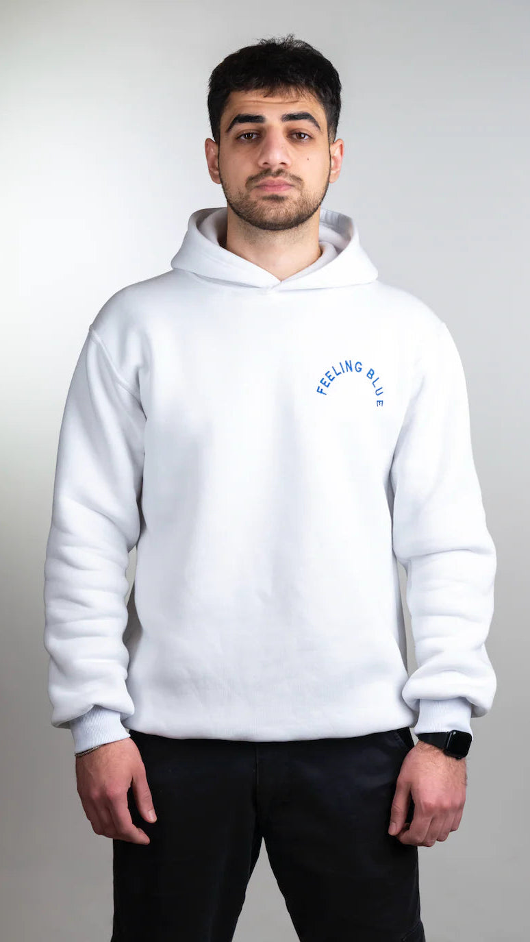 Person wearing a white hoodie with text on a plain background