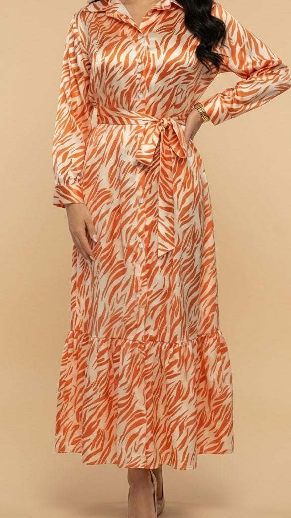 Woman wearing an orange and white patterned dress on a beige background